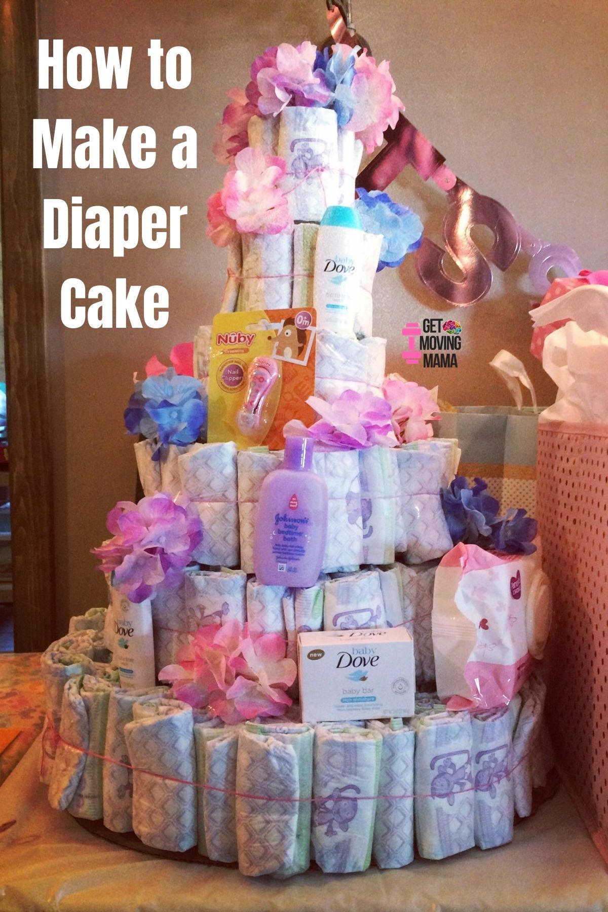 A picture of a DIY diaper cake decorated with pink and purple 