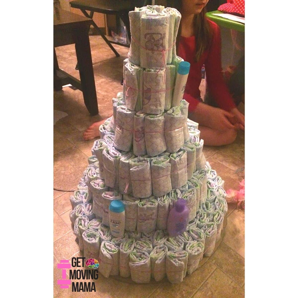 A picture of a diaper cake with a few baby travel sized toiletries added.