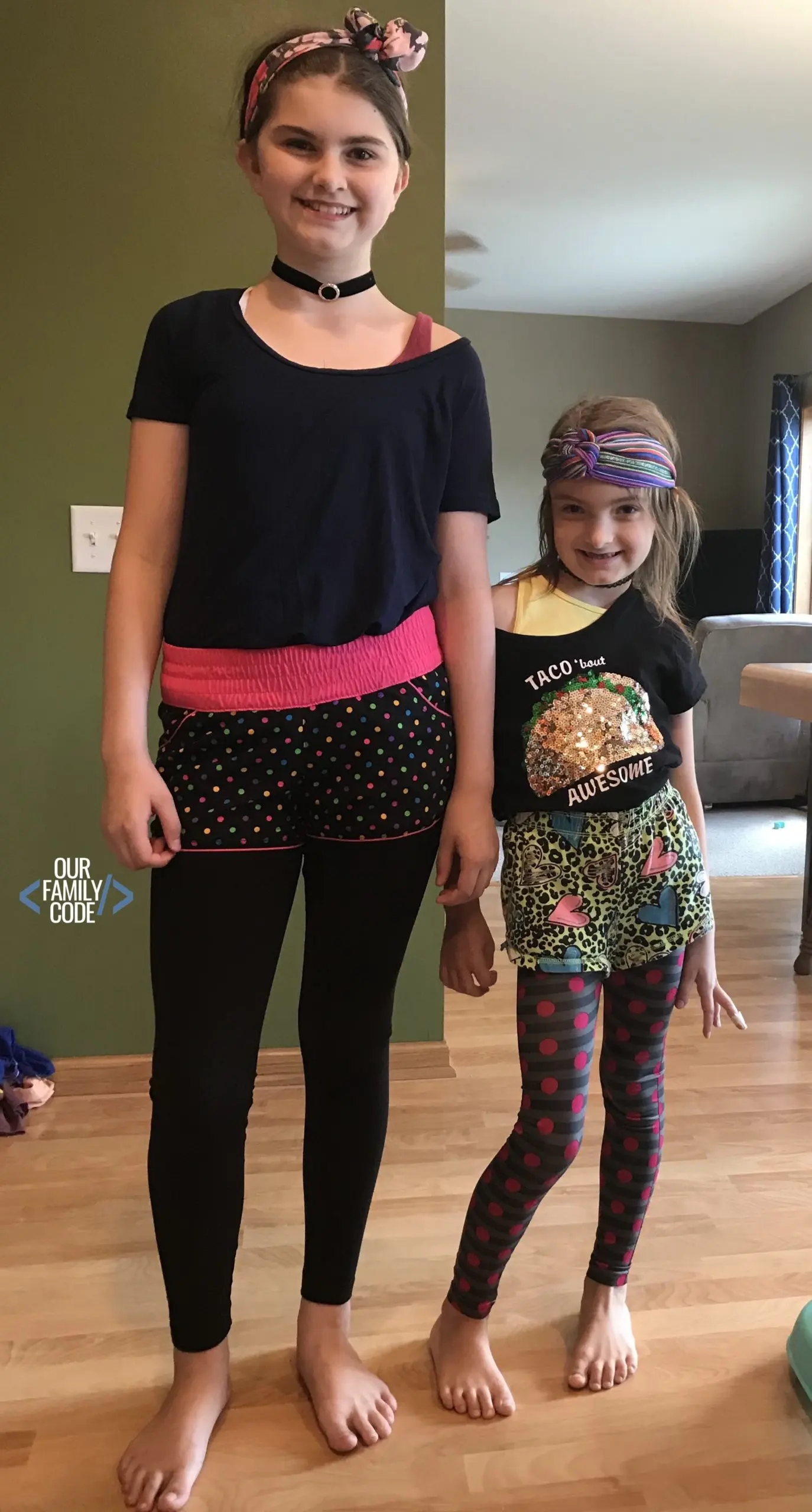 A picture of two young girls dressed in 80s Halloween Costumes.