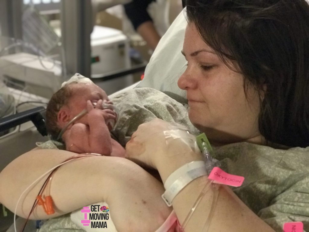 A picture of a mom holding a preemie in the nicu after high risk birth.