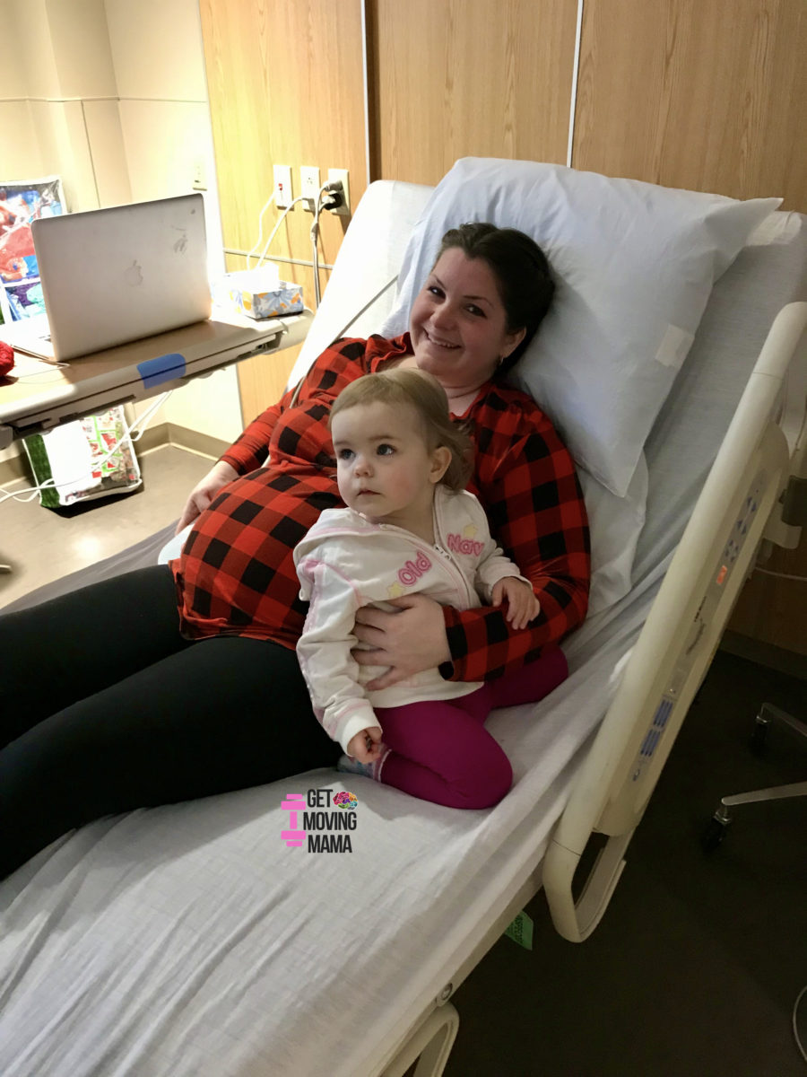 A picture of a mom and a toddler sitting on a hospital bed in an antepartum unit.