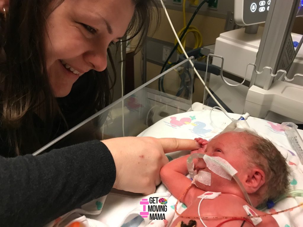 preemie in the nicu holding mom's finger