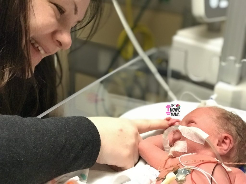 preemie in the nicu holding mom's finger