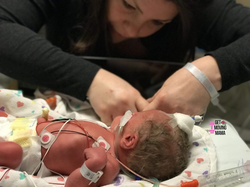 preemie in the nicu holding mom's finger