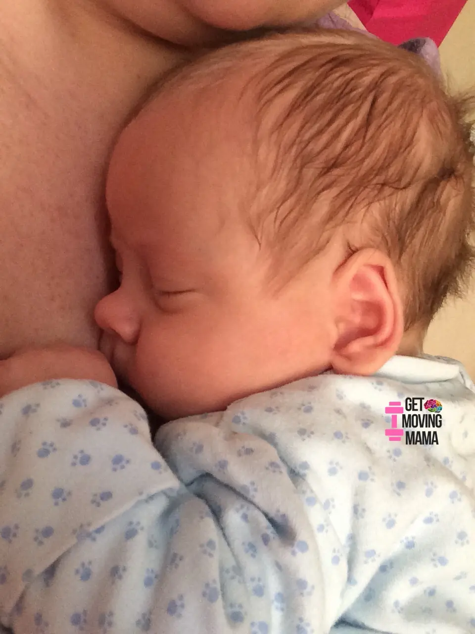 A baby snuggling against a mom's chest.